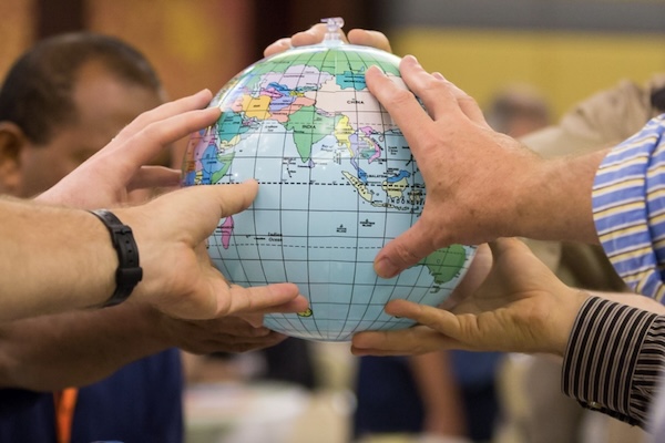 Group of people holding inflatable globe