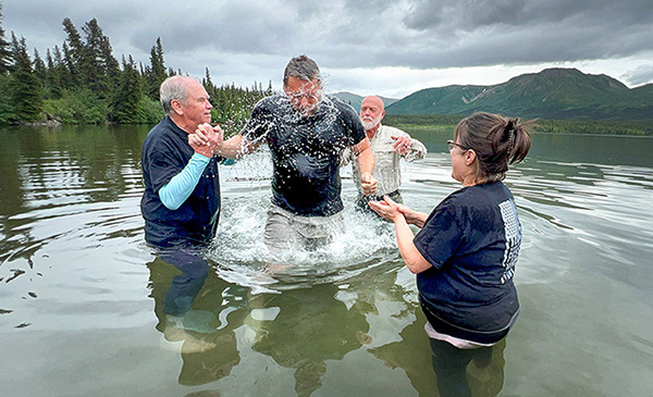 Man Getting Baptized in Alaskan Lake