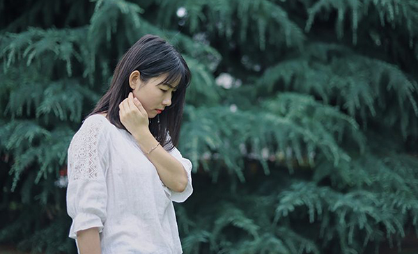 Woman Walking in Front of Trees