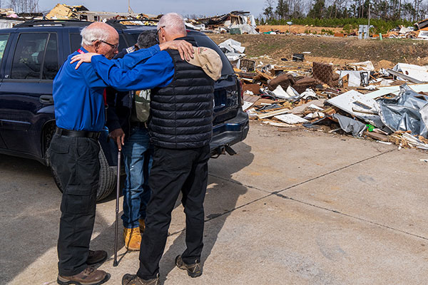 Chaplain Praying with Men
